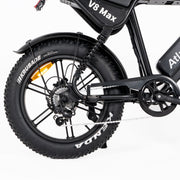Close-up of a black electric bicycle showing the rear wheel, fender, chain guard, battery pack, and part of the frame on a white studio background.