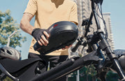 Person adjusting a bike seat on an electric bike with a blurred background
