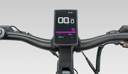 A close-up of a black electric bicycle handlebar with a mounted digital display screen showing speed and battery status, set against a neutral gray background.