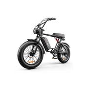 A black electric fat-tire bicycle with a round headlight, front suspension fork, rear suspension, and a black seat, shown on a clean white background.