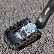 Semi-aluminum folding pedal with reflectors on a road surface