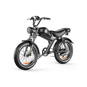 A black electric mini motorcycle with fat tires, a round headlight, and a step-through frame, shown from a three-quarters front angle on a white background. The brand 'EVO' is visible on the fuel tank, and 'KENDA' is visible on the front tire.