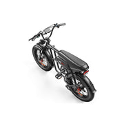 A black electric fat-tire bicycle with a sleek black seat, black frame, and small orange accents on the wheel spokes, shown from an elevated rear-three-quarter angle on a solid white background.