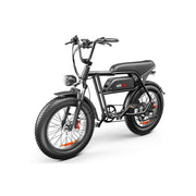A black electric bicycle with fat tires, a step-through frame, and a rear cargo seat, photographed on a clean white background. The battery pack is mounted on the frame, and the brand name 'em moto' is visible on the side.