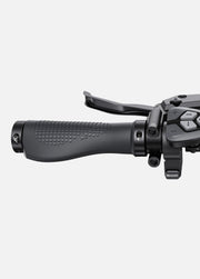 Close-up of a black motorcycle throttle grip on a white background