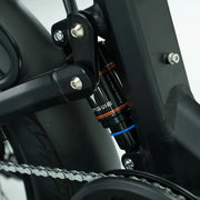 Close-up of a bicycle suspension fork with 'Shimano' branding on a blurred background