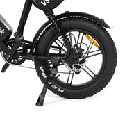 Close-up of a black electric bike wheel with visible branding on a white background